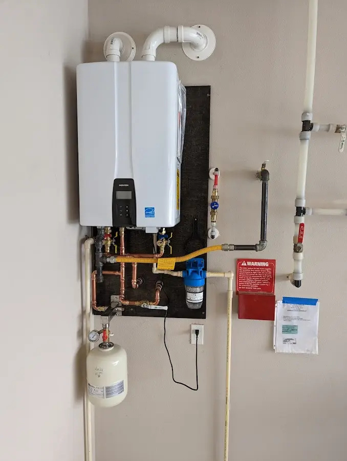 Professional plumber installing copper piping in a Atkinson home